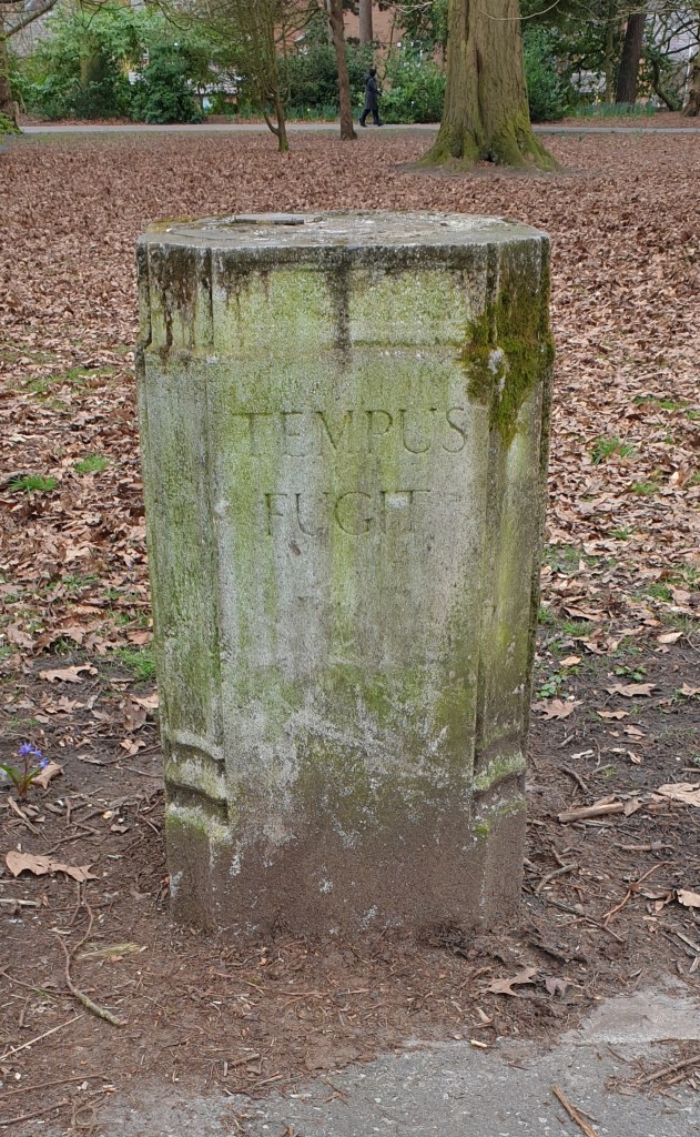 Stone pillar engraved with the Latin words Tempus Fugit